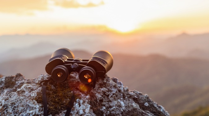 binoculars on top of a rock